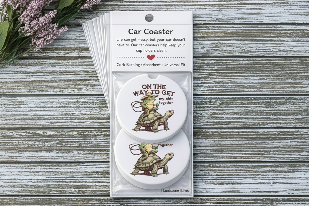 Car coaster set with cartoon turtles and humorous text in packaging on a wooden surface